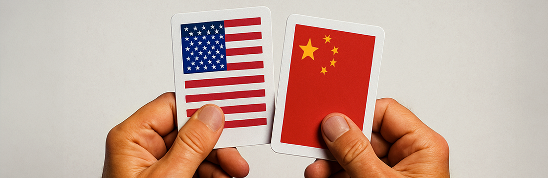 Hands holding playing cards with U.S. and China flags, symbolizing US-China trade relations and economic rivalry