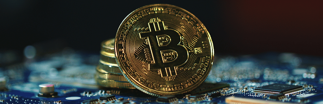 Bitcoin coin on a computer circuit board symbolizing the 2025 liquidity crisis in crypto and emerging equity markets.