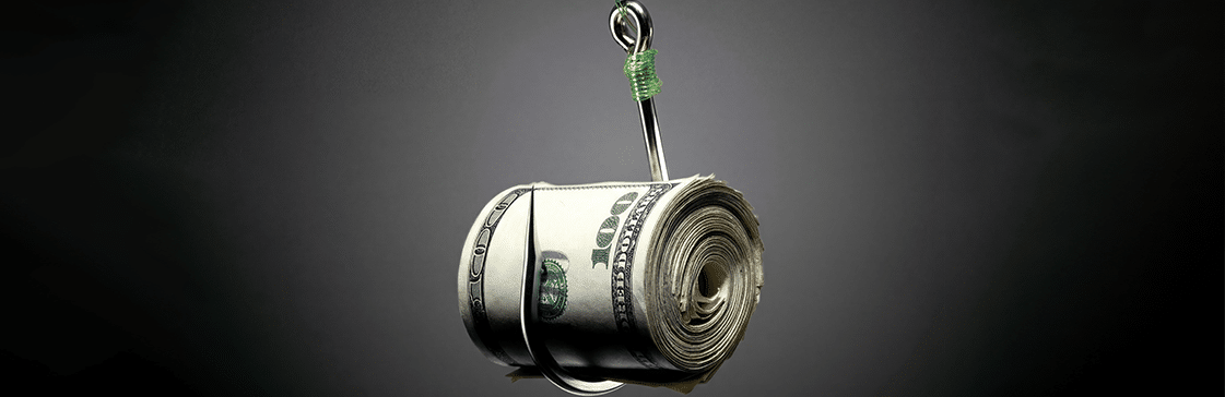A fishing hook holding a rolled bundle of US dollar bills — illustrating the hidden risk in trades that appear too good to be true, as explored in The Big Short analysis.